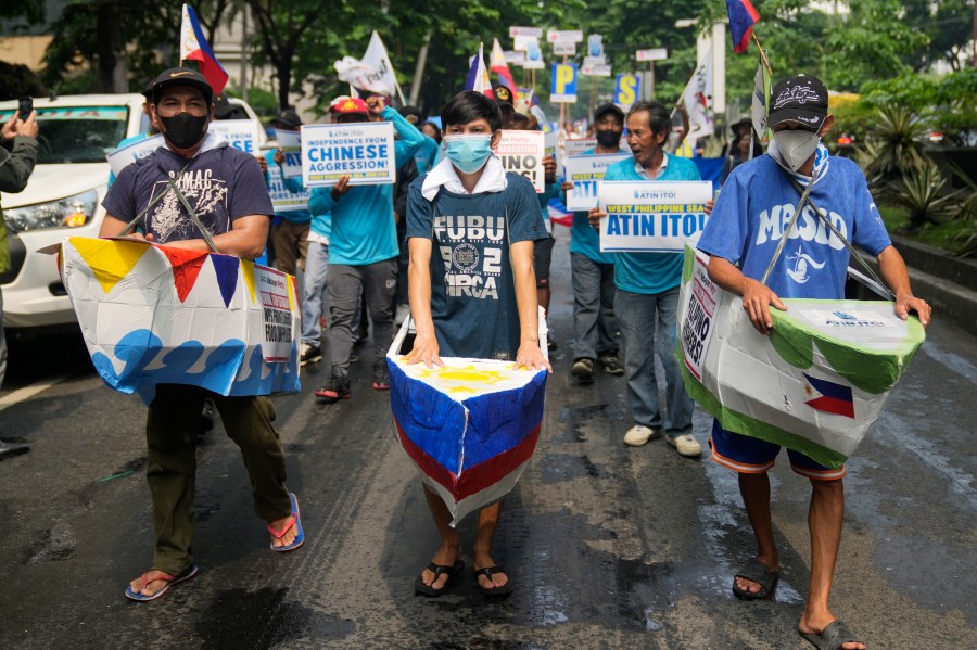 FILE - Filipino fishermen and activists wear boat costumes to protest against alleged Chinese aggression at the disputed South China Sea as they stage a rally in front of the Chinese consulate ahead of Independence Day in Makati, Philippines, June 11, 2024. (AP Photo/Aaron Favila, File)