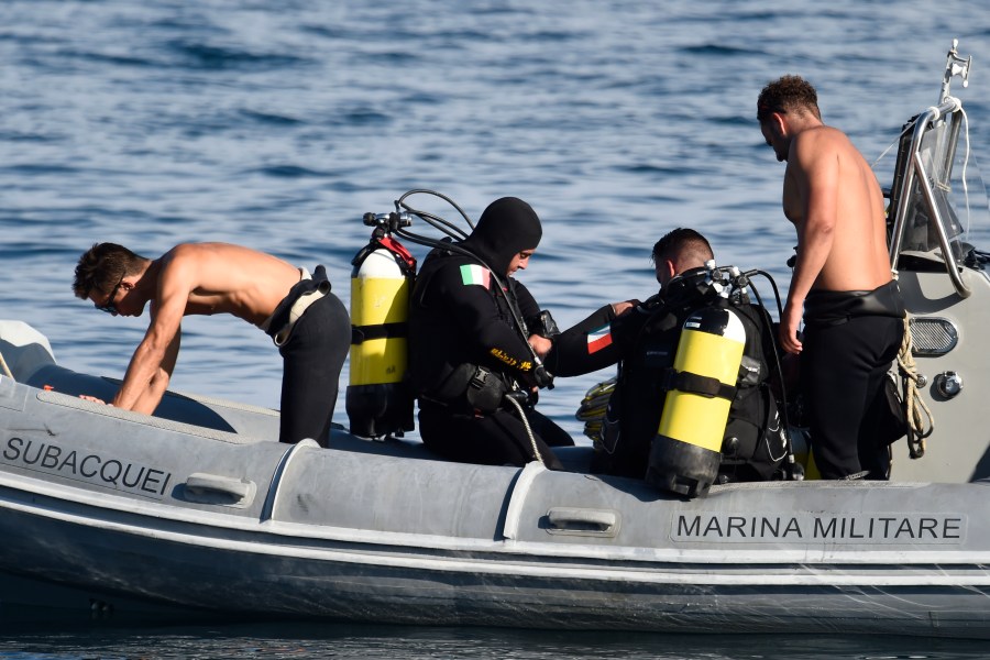 Italian Navy scuba divers work at the scene of the search for a missing boat, in Porticello, southern Italy, Thursday, Aug. 22, 2024. Rescue teams and divers returned to the site of a storm-sunken super yacht to search for one person, who are believed to be still trapped in the hull 50 meters (164-feet) underwater. (AP Photo/Salvatore Cavalli)