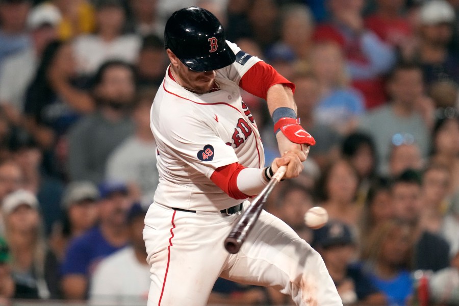 Boston Red Sox's Danny Jansen connects for an RBI single in the eighth inning of a baseball game against the Texas Rangers at Fenway Park, Wednesday, Aug. 14, 2024, in Boston. (AP Photo/Charles Krupa)