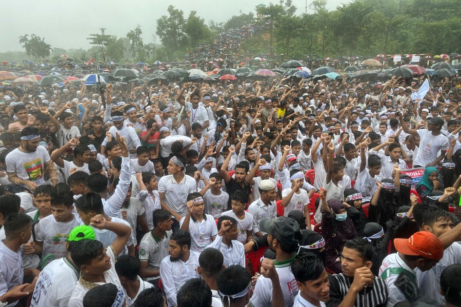 Hundreds of Rohingyas gather in the rain to demand safe return to Myanmar's Rakhine state as they mark the seventh anniversary of their mass exodus from Myanmar at their refugee camp at Kutupalong in Cox's Bazar district, Bangladesh, Sunday, Aug. 25, 2024. (AP Photo/ Shafiqur Rahman)