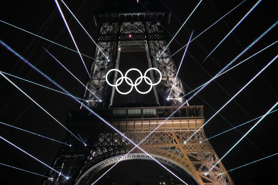 FILE -A light show is projected from the Eiffel Tower in Paris, France, during the opening ceremony of the 2024 Summer Olympics, July 26, 2024. (AP Photo/David J. Phillip, File)