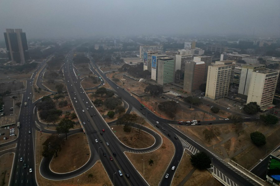 Smoke from wildfires hovers over the city amid dry weather in Brasilia, Brazil, early Monday, Aug. 26, 2024. (AP Photo/Eraldo Peres)