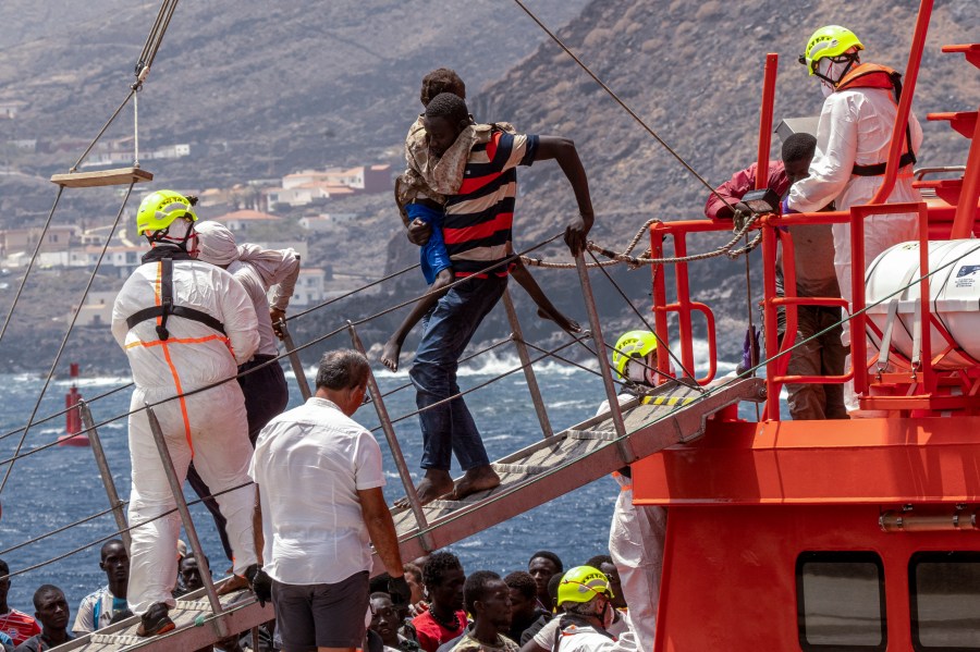 Migrants disembark at the port of "La Estaca" in Valverde at the Canary island of El Hierro, Spain, Monday, Aug. 26, 2024, after they arrived by boat from a thirteen-day voyage from the coast of Senegal. (AP Photo/Maria Ximena)