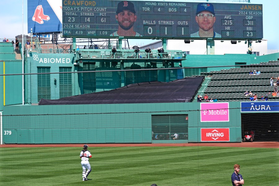 Boston Red Sox catcher Danny Jansen heads to the bullpen to prior baseball game, which was delayed due to rain in June, against the Toronto Blue Jays at Fenway Park, Monday, Aug. 26, 2024, in Boston. Jansen, who was traded by the Blue Jays to the Red Sox on July 27th, is in the line-up against his former team when the delayed game continues Monday afternoon. Jansen will become the first major league player to appear in the same game for both teams. (AP Photo/Charles Krupa)