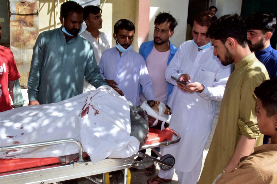 Relatives gather around a body of a passenger, killed by gunmen at a highway in Musakhail, as they wait for transportation at a hospital, in Quetta, Pakistan, Monday, Aug. 26, 2024. (AP Photo/Arshad Butt)