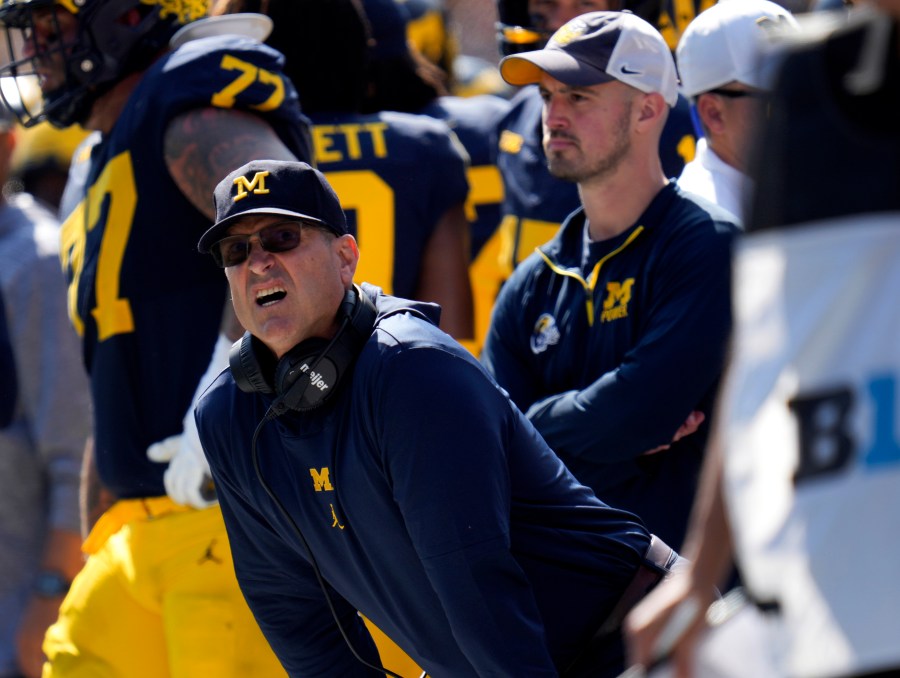 FILE - Michigan head coach Jim Harbaugh, front left, watches against Rutgers as analytics assistant Connor Stalions, right, looks on during an NCAA college football game in Ann Arbor, Mich., Sept. 23, 2023. (AP Photo/Paul Sancya, File)