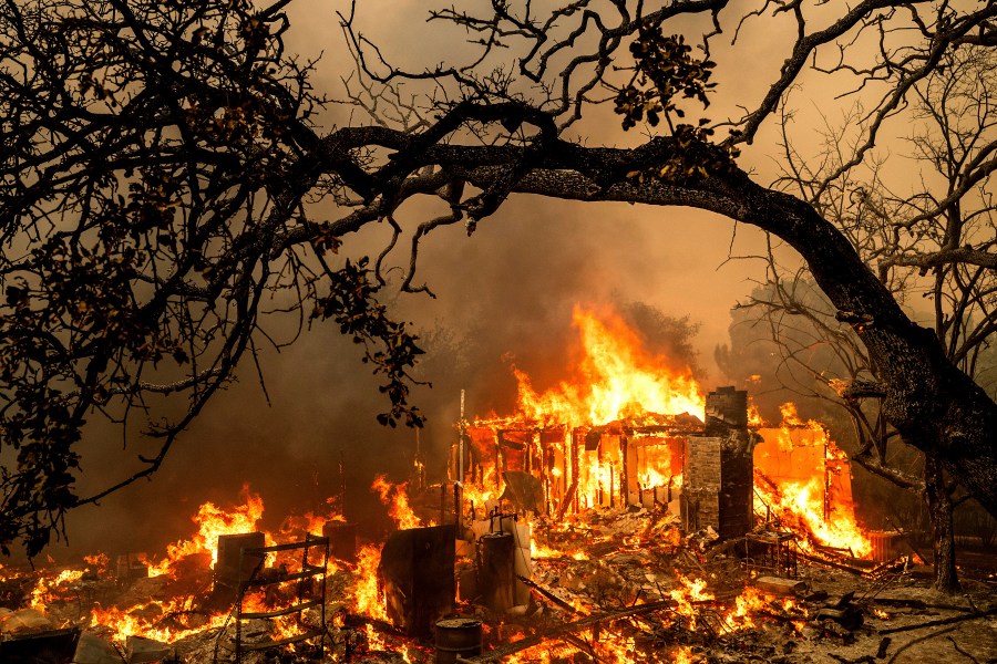 FILE - Flames consume a structure on Bessie Lane as the Thompson Fire burns in Oroville, Calif., July 2, 2024. (AP Photo/Noah Berger,File)