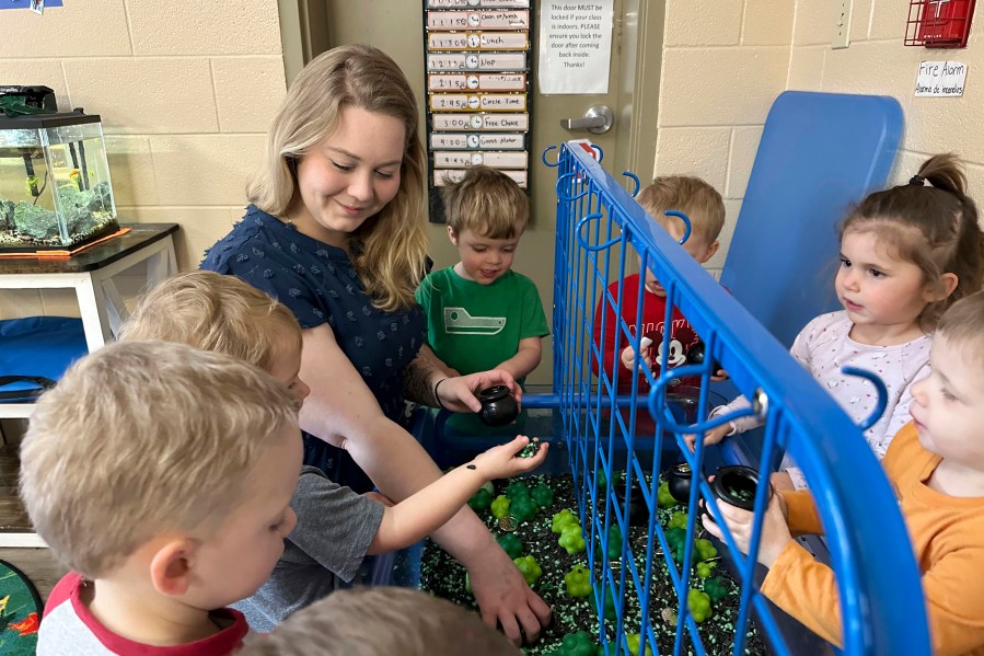 FILE - Rylee Monn plays with children in her class at a child care center in Lexington, Ky., March 13, 2024. (AP Photo/Dylan Lovan, File)