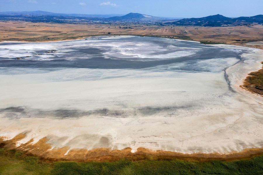 The dried out Lake Picrolimni is seen from above, near the village of Mikrokampos, northern Greece, Aug. 19, 2024. A severe drought in northern Greece, worsened by successive heatwaves and low rainfall, is causing water shortages that are threatening agriculture, drying up lakes, and stressing local communities dependent on tourism. (AP Photo/Giannis Papanikos)