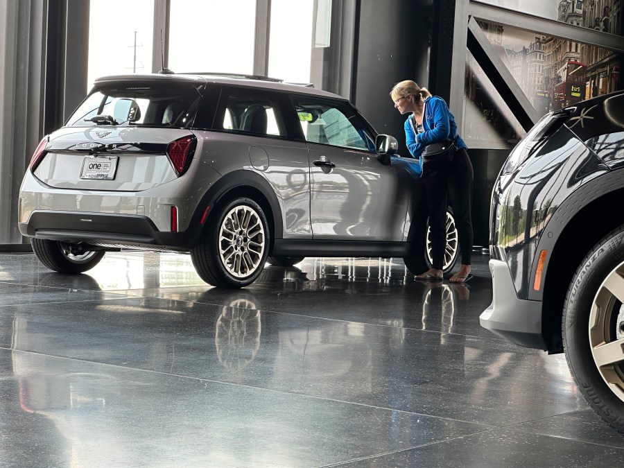 A prospective buyer examines a 2025 Cooper S hardtop on display on the showroom floor of a Mini dealership Monday, July 22, 2024, in Highlands Ranch, Colo. (AP Photo/David Zalubowski)