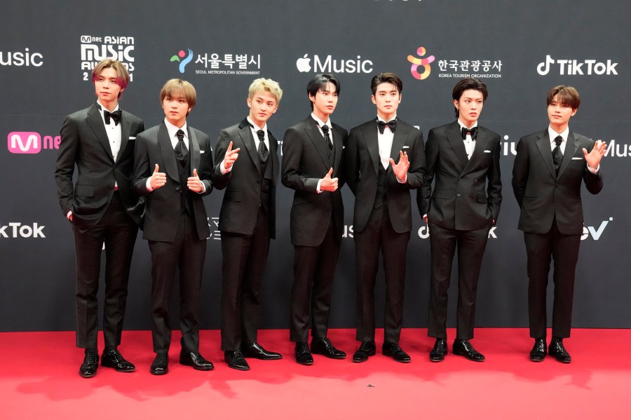 FILE- South Korean singer Taeil, right, poses with other members of K-Pop group NCT 127 upon arrival at the 2021 Mnet Asian Music Awards or 2021 MAMA in Paju, South Korea, Saturday, Dec. 11, 2021. (AP Photo/Lee Jin-man, File)