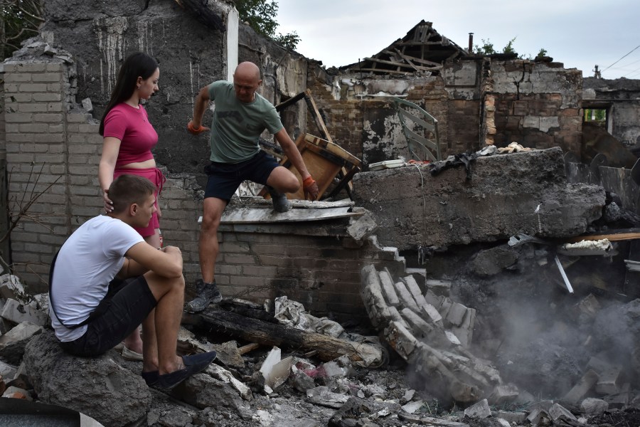 A couple sit in front of their house destroyed by a Russian strike in Zaporizhzhia, Ukraine, Tuesday, Aug. 27, 2024. (AP Photo/Andriy Andriyenko)