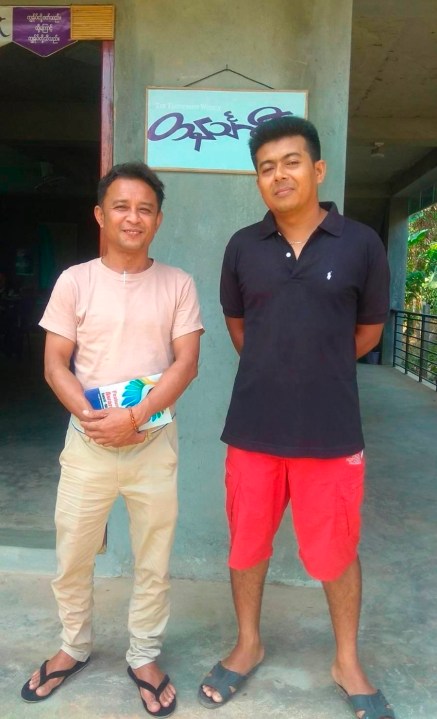 Aung San Oo, left, and Myo Myint Oo, pose for a picture in front of the office of the Tanintharyi Weekly Journal published by Dawei Watch media, in Dawei township in Tanintharyi region, Myanmar, in 2020. A military court in Myanmar has given a life prison sentence to a local journalist and sentenced one of his colleagues to 20 years after convicting them under a counterterrorism law, their editor said Wednesday. (Zaw Zaw (Myeik) via AP)