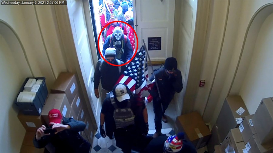 This image from video from the Justice Department in the statement of facts supporting an arrest warrant, and annotated by the source, shows Dan Edwin Wilson, circled in red, entering the U.S. Capitol on Jan. 6, 2021, in Washington. (Department of Justice via AP)