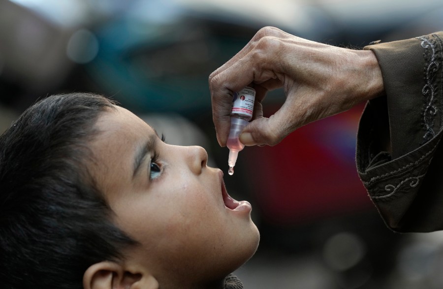 FILE - A health worker administers a polio vaccine to a child in Karachi, Pakistan, Monday, Jan. 8, 2024. (AP Photo/Fareed Khan, File)