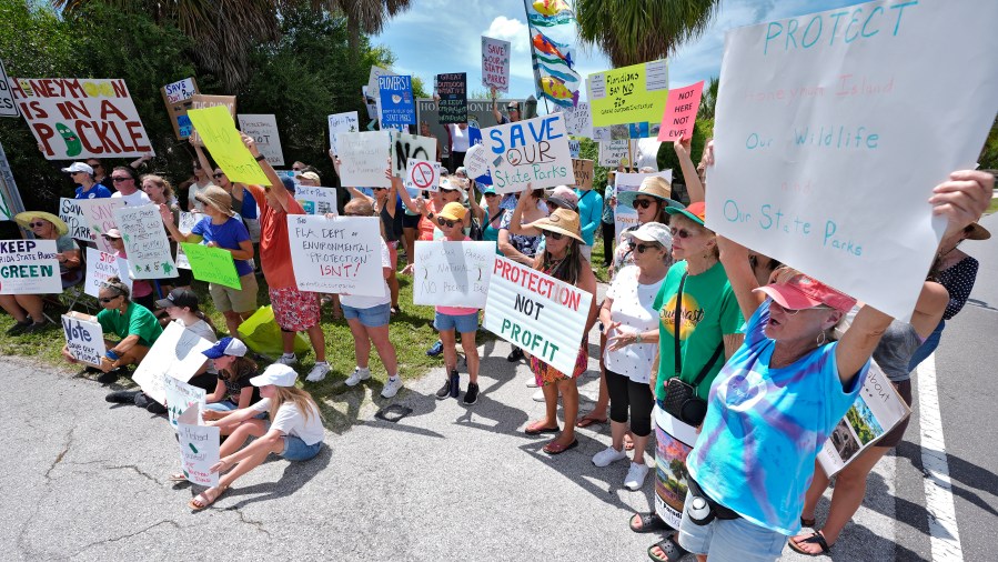 Protestors against development at Florida's state parks gather for a rally at the entrance to Honeymoon Island State Park Tuesday, Aug. 27, 2024, in Dunedin, Fla. (AP Photo/Chris O'Meara)