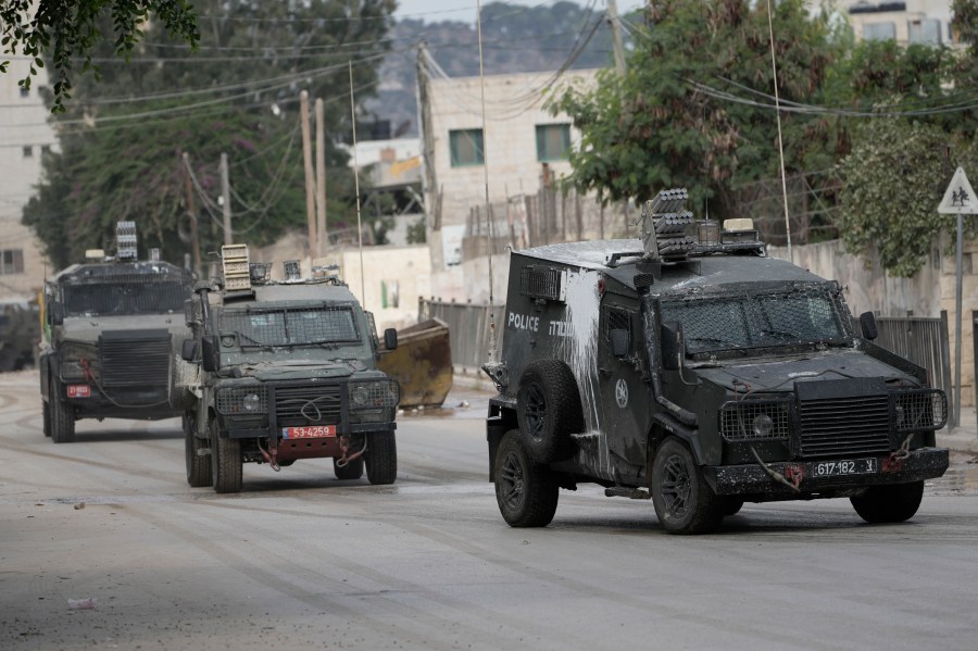 Israeli armoured vehicles move on a street during a military operation in the West Bank city of Jenin, Wednesday, Aug. 28, 2024. (AP Photo/Majdi Mohammed)