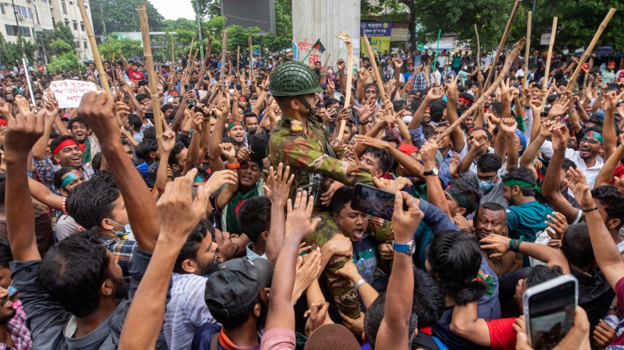 Protesters carry a member of the army on their shoulders as they celebrate Prime Minister Sheikh Hasina's resignation, in Dhaka, Bangladesh, Monday, Aug. 5, 2024.