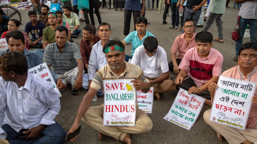 Bangladeshi Hindu protesters are holding placards during the demonstration in Dhaka, Bangladesh, on August 12, 2024, against the recent religious violence against the Hindu community in Bangladesh. Hindus, who make up about 8% of Bangladesh's population of 170 million, are traditionally supporting Hasina's Awami League party, which is sparking people's anger after violent clashes between anti-quota protesters and security forces recently. (Photo by Ahmed Salahuddin/NurPhoto via Getty Images)