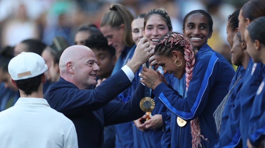 Gianni Infantino, President of FIFA, gives Gold Medalist Trinity Rodman #5 of Team United States her medal during the Women's Football medal ceremony Women's Gold Medal match between Brazil and United States of America during the Olympic Games Paris 2024 at Parc des Princes on August 10, 2024 in Paris, France. (Photo by Carl Recine/Getty Images)