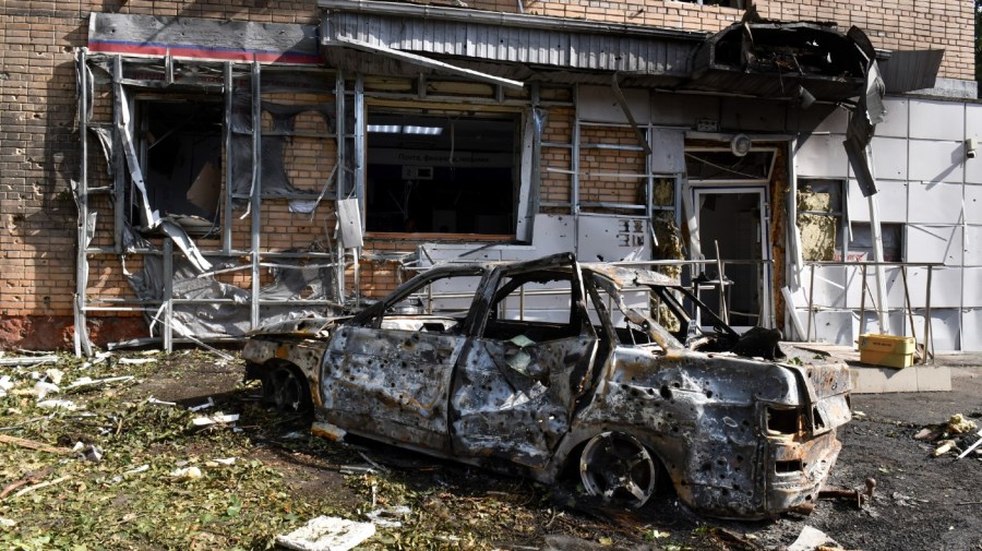 A burned car is seen in front of an apartment building damaged after shelling by the Ukrainian side in Kursk, Russia, Sunday, Aug. 11, 2024. (AP Photo)