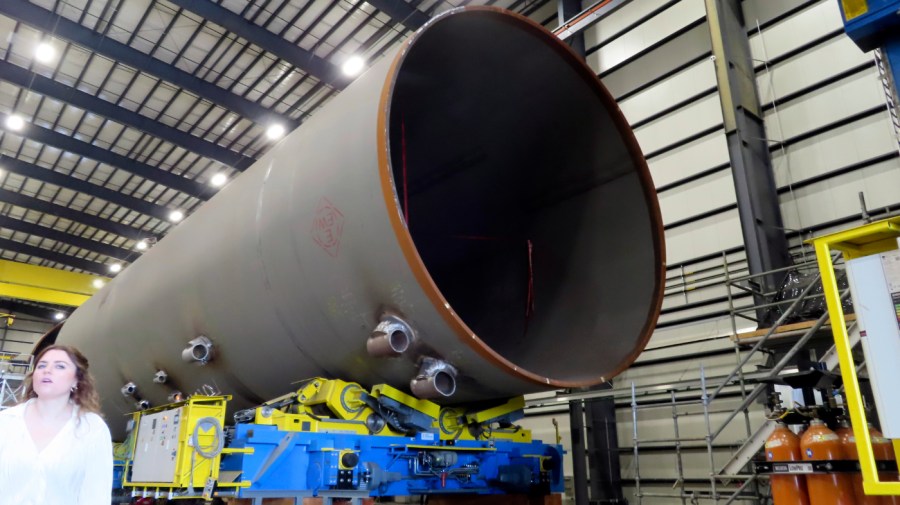 A huge foundation for an offshore wind turbine, called a monopile, sits in a construction facility in Paulsboro, N.J., Thursday, July 6, 2023. A tangle of litigation is delaying the start of New Jersey's first offshore wind energy project, as developer Orsted is suing governments to stop delaying necessary permits, and citizens groups try to halt the project altogether. (AP Photo/Wayne Parry)