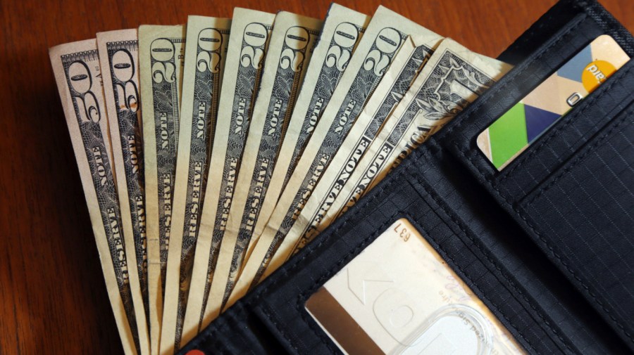 In this June 15, 2018, file photo, cash is fanned out from a wallet in North Andover, Mass. Financial shocks are bound to hit at some point, and building financial resilience can make it easier to handle them when they do. Financial resilience means being able to get through a difficult time, whether it’s a surprise bill or a layoff. To strengthen your financial resilience, it helps to cut back on unnecessary expenses, build a savings reserve and protect your credit so it’s available if you need it. (AP Photo/Elise Amendola, File)