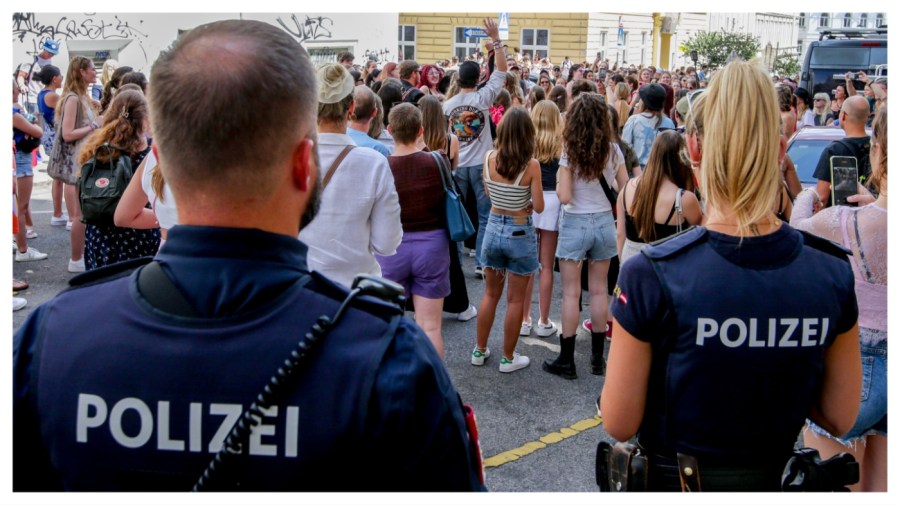 Police officers stand near gathering swifties in Vienna on Friday, Aug.9, 2024. Organizers of three Taylor Swift concerts in the stadium in Vienna this week called them off on Wednesday after officials announced arrests over an apparent plot to launch an attack on an event in the Vienna area such as the concerts. (AP Photo/Heinz-Peter Bader)