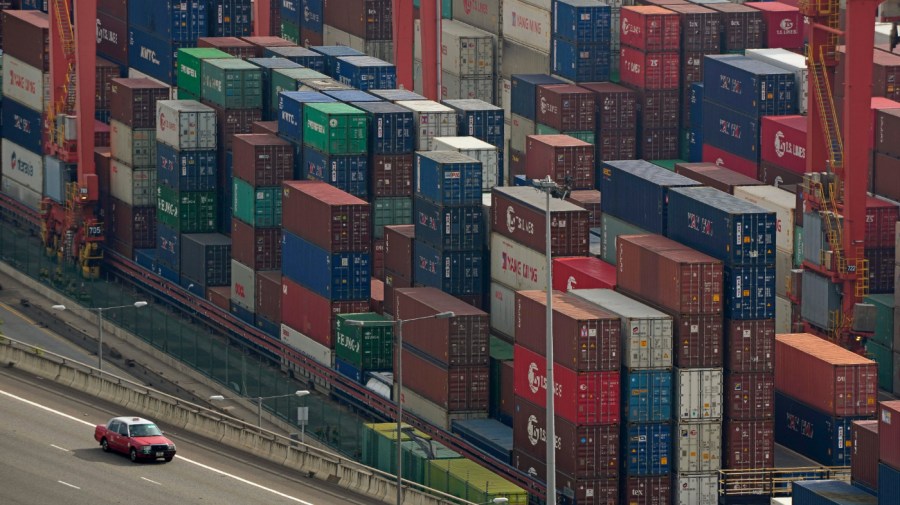 Shipping containers are seen at a port of Kwai Tsing Container Terminals in Hong Kong, Friday, Nov. 5, 2021. The United States has accused China in a report Wednesday, Feb. 16, 2022, of failing to meet its commitments to the World Trade Organization. (AP Photo/Kin Cheung, File)