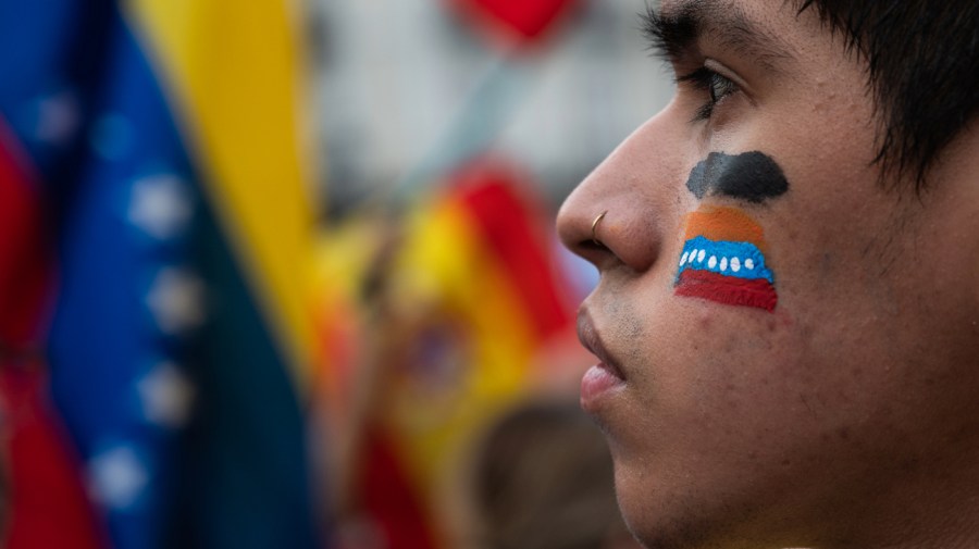 A man with a Venezuelan flag painted on his face is seen during a demonstration. Venezuelans residing in Madrid gathered in Puerta del Sol to protest and express their disagreement with the election results in Venezuela and give support to opposition leader Maria Corina Machado and opposition candidate Edmundo Gonzalez. (Photo by Marcos del Mazo/LightRocket via Getty Images)