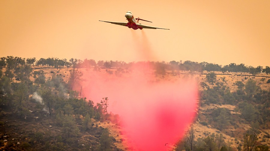 An air tanker drops fire retardant on a ridge near the Paynes Creek area of unincorporated Tehama County, California, as the Park fire continues to burn on July 27, 2024. The fast-moving and rapidly growing wildfire has forced more than 4,000 people to evacuate as firefighters battle gusty winds and perilously dry conditions, authorities said on July 26, 2024. An arsonist is suspected to have started the fire which has burned more than 340,000 acres and burned dozens of homes. (Photo by JOSH EDELSON / AFP) (Photo by JOSH EDELSON/AFP via Getty Images)