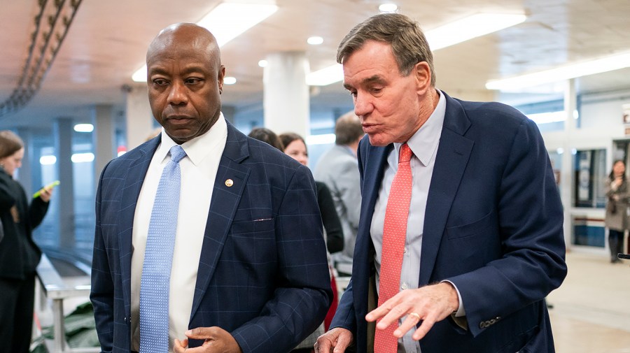 Sen. Tim Scott (R-S.C.) speaks with Sen. Mark Warner (D-Va.)