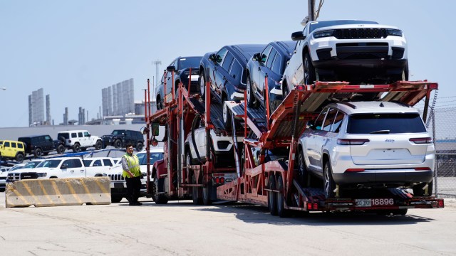 FILE - A transport carrying new cars arrives at a Stellantis facility July 10, 2023, in Belvidere. Ill. (AP Photo/Charles Rex Arbogast, File)