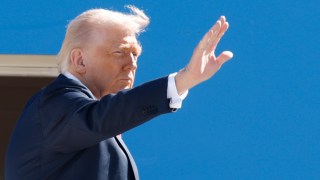 President Trump waves from the stairs of Air Force One